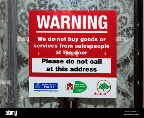 warning sign    buy goods  services   door stock photo