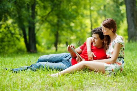 Beautiful Romantic Couple With Tablet Pc At Summer Green