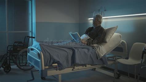 Smiling Senior Woman Posing In A Hospital Bed Stock Image