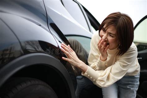 female checking for car scratches stock image image of model