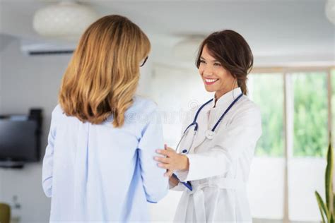 Female Doctor Consulting Her Patient While Standing In Doctor`s Office