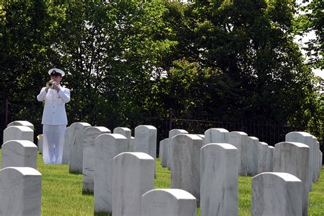 a navy bugler plays “taps” at the interment service for former dia