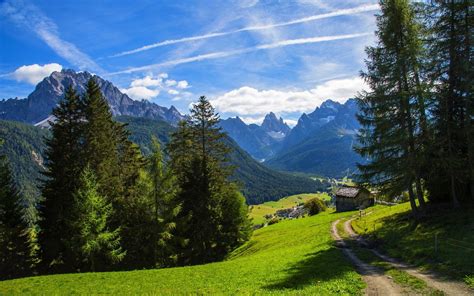 nature landscape mountain alps valley path forest summer clouds grass trees hut