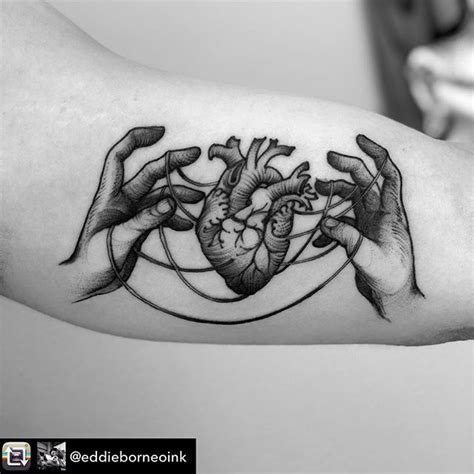black  white photo   hands holding  heart tattoo   left arm