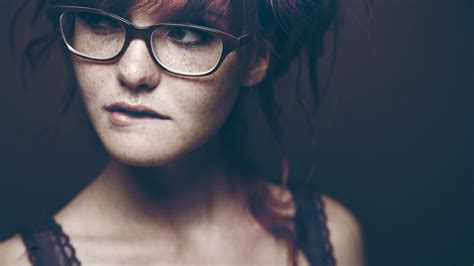 model redhead freckles glasses closeup biting lip