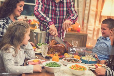 young father carving roasted thanksgiving turkey high res stock photo getty images
