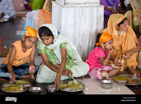 indian women eating  thali traditional indian meal  golden