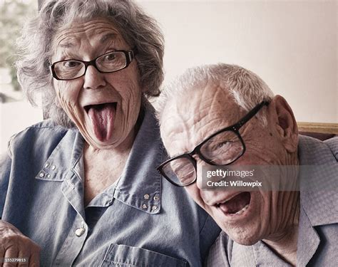 Grandma And Grandpa Making Funny Tongue Wagging Faces High Res Stock