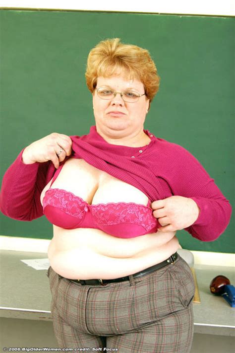 glassed fat mature teacher stripping and posing in classroom