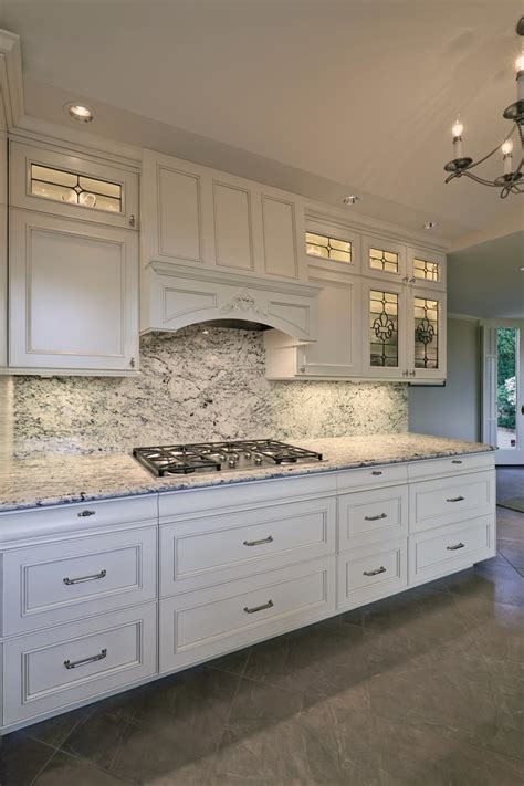 Light Airy Kitchen With Leaded Glass Front Cabinets And Under Cabinet