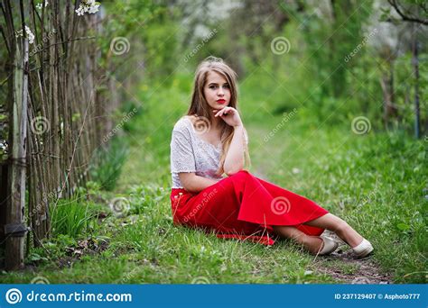 Portrait Of Beautiful Girl With Red Lips At Spring Blossom Garden Stock