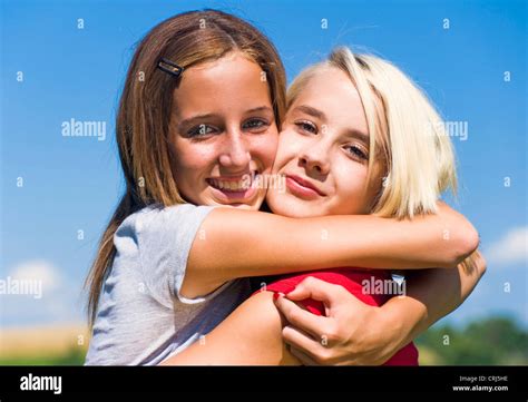 teenage girls holding eachother   embrace stock photo alamy