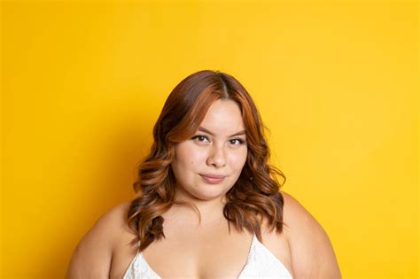 Portrait Of Mixed Race Redhead Plus Size Model Looking At Camera Stock