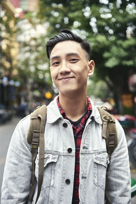 portrait  young vietnamese man  backpack   city stock photo  gpointstudio