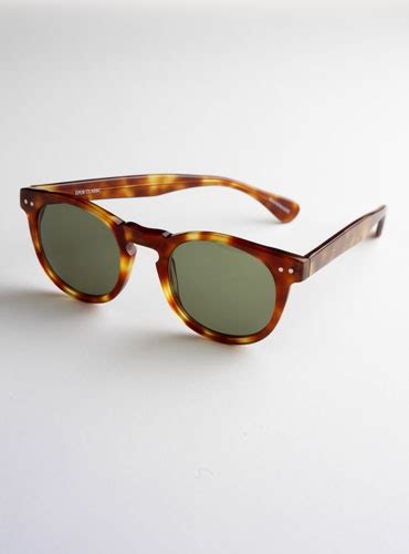 semi round sunglasses in amber with green lenses