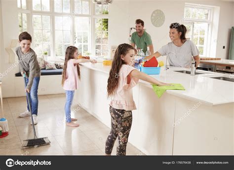 children helping parents  household chores stock photo