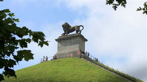 statue   lion  top   green hill  people standing