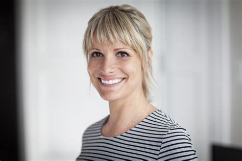 portrait of a mature woman smiling at the camera at home byron