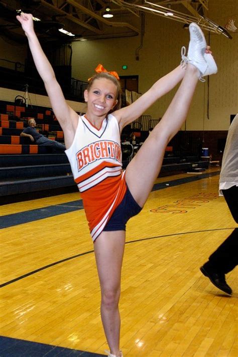 Cheer Brighton High School Cheerleader During Heel Stretch In Gym