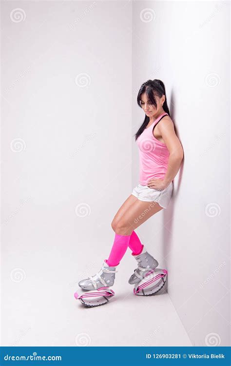 beautiful athletic woman wearing  sports style clothing  kangoo jumps boots   legs