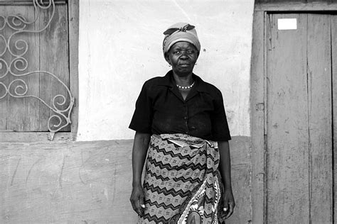 a zambian woman stands outside her house smithsonian photo contest
