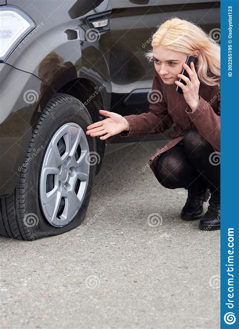 young blonde woman talking   mobile phone   car   flat