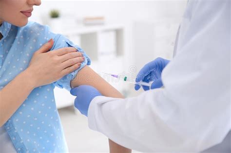 doctor giving injection to patient vaccination concept