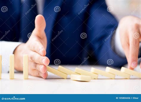 young businessman playing  domino  office stock photo image  danger domino