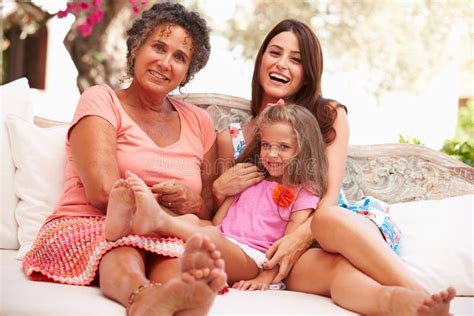 Grandmother Mother And Granddaughter Sitting Outdoors Stock Image