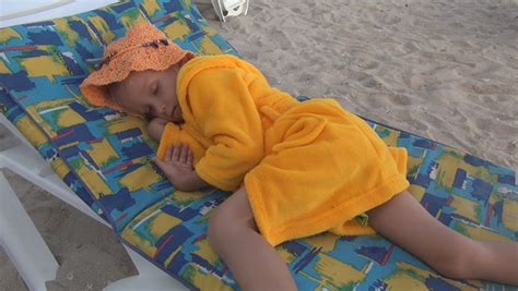 child  girl sleeping  beach sleepy kid  seashore children lifestyle stock footage
