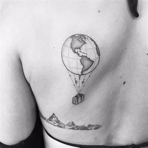 hot air balloon globe tattoo for a traveler on left mid back