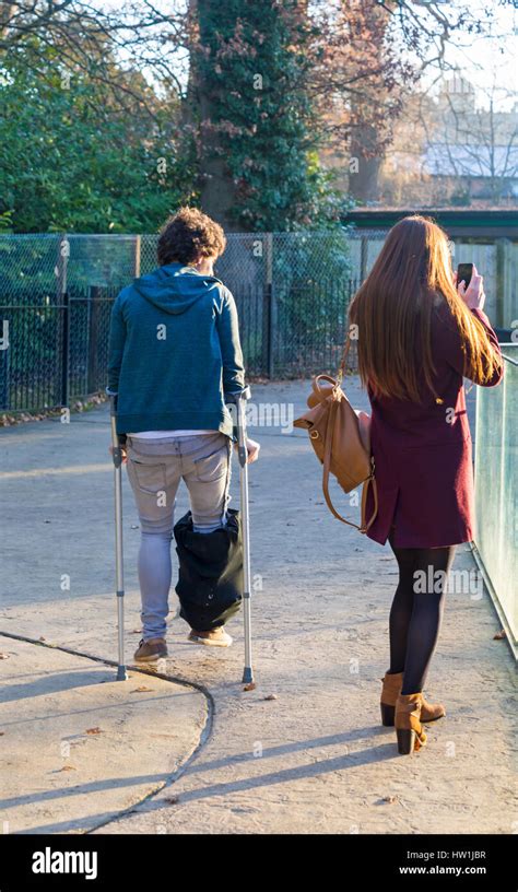 man  bad leg walking  crutches  girlfriend stops    photo  longleat safari