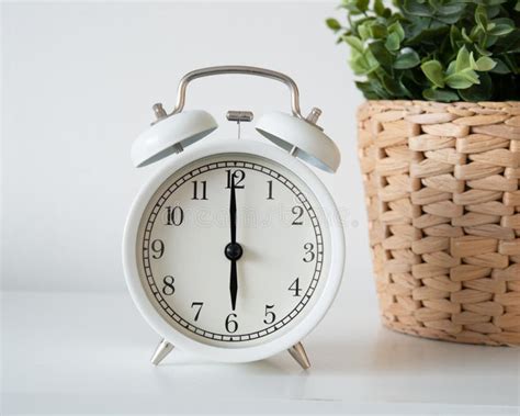 white vintage alarm clock showing time     morning