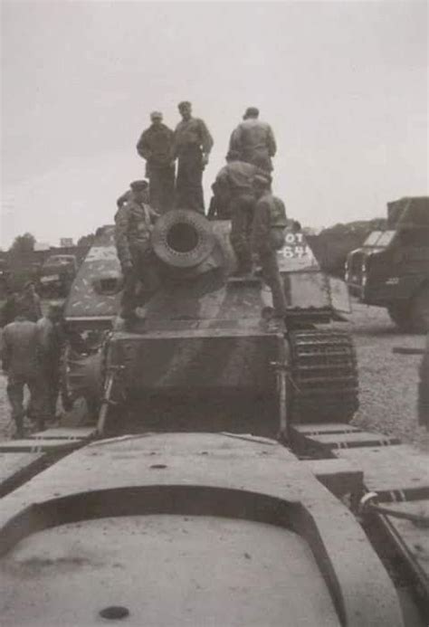american soldiers inspecting  captured sturmtiger tank transport