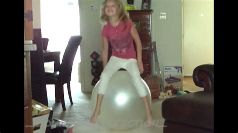 Girl Bouncing On A Big Gym Ball With Feet Almost Not Touch The Floor