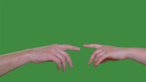 Two People Hands Touching With Index Fingers Isolated On Green