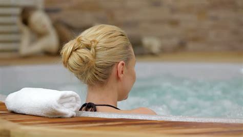 beautiful woman relaxing in a hot tub happy woman relaxing in jacuzzi woman in spa salon