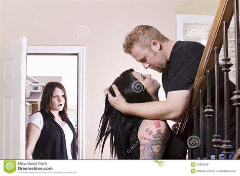 wife coming home finding her husband cheating stock image