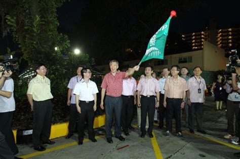prime minister lee hsien loong flagging  trucks making