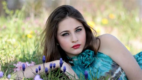 Grey Eyes Girl Model Is Lying Down On Green Grass Wearing Blue Dress Hd