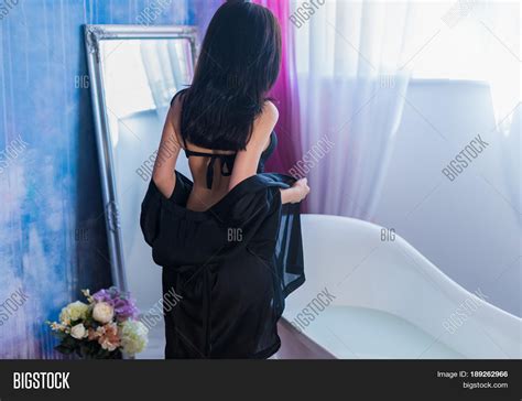 sexy brunette woman taking off her image and photo bigstock