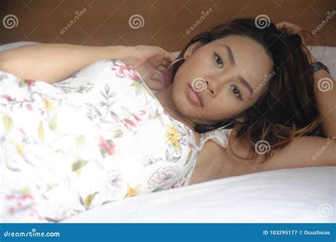 Young Attractive And Beautiful Asian Woman Lying On Bed At Bedroom