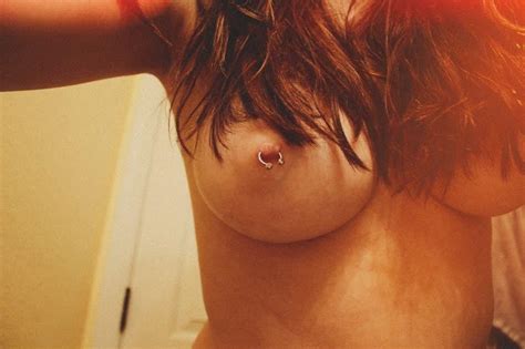 brunette hottie with pierced nipples poses on webcam