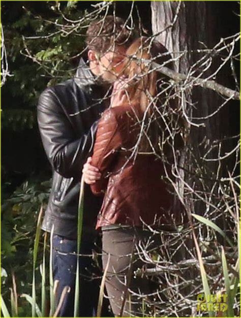 jamie dornan and dakota johnson kiss in the woods for fifty shades of
