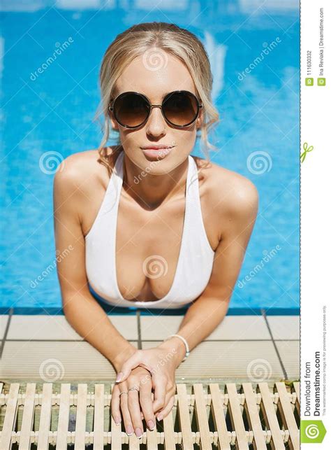 Blonde Model Girl In Bikini And Sunglasses Is Looking In Camera In
