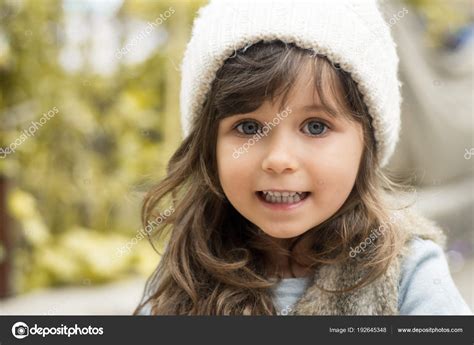 beautiful little brunette girl blue eyes outdoor portrait