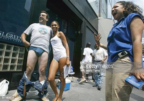 A Man Strips With A Model In Times Square On The Photo