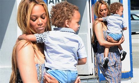 tyra banks sports baggy strapless jumpsuit to take her son york shopping in los angeles daily
