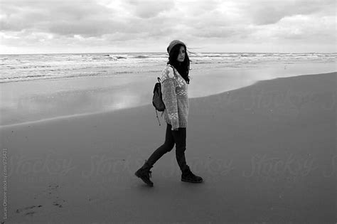 Black And White Woman Walking Along The Beach In Winter By Lucas