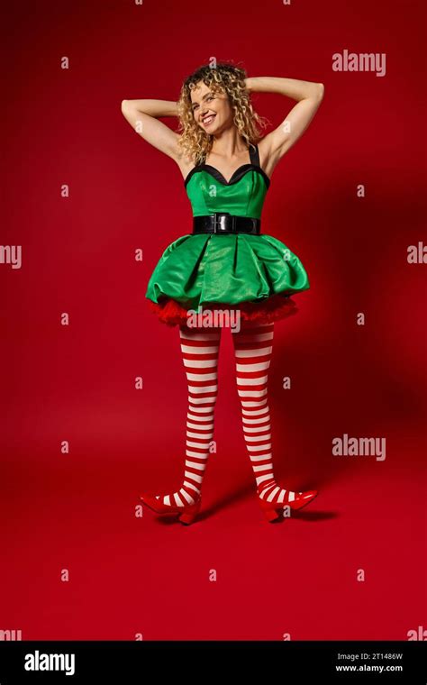 Cheerful New Year Elf In Green Festive Dress And Striped Stockings
